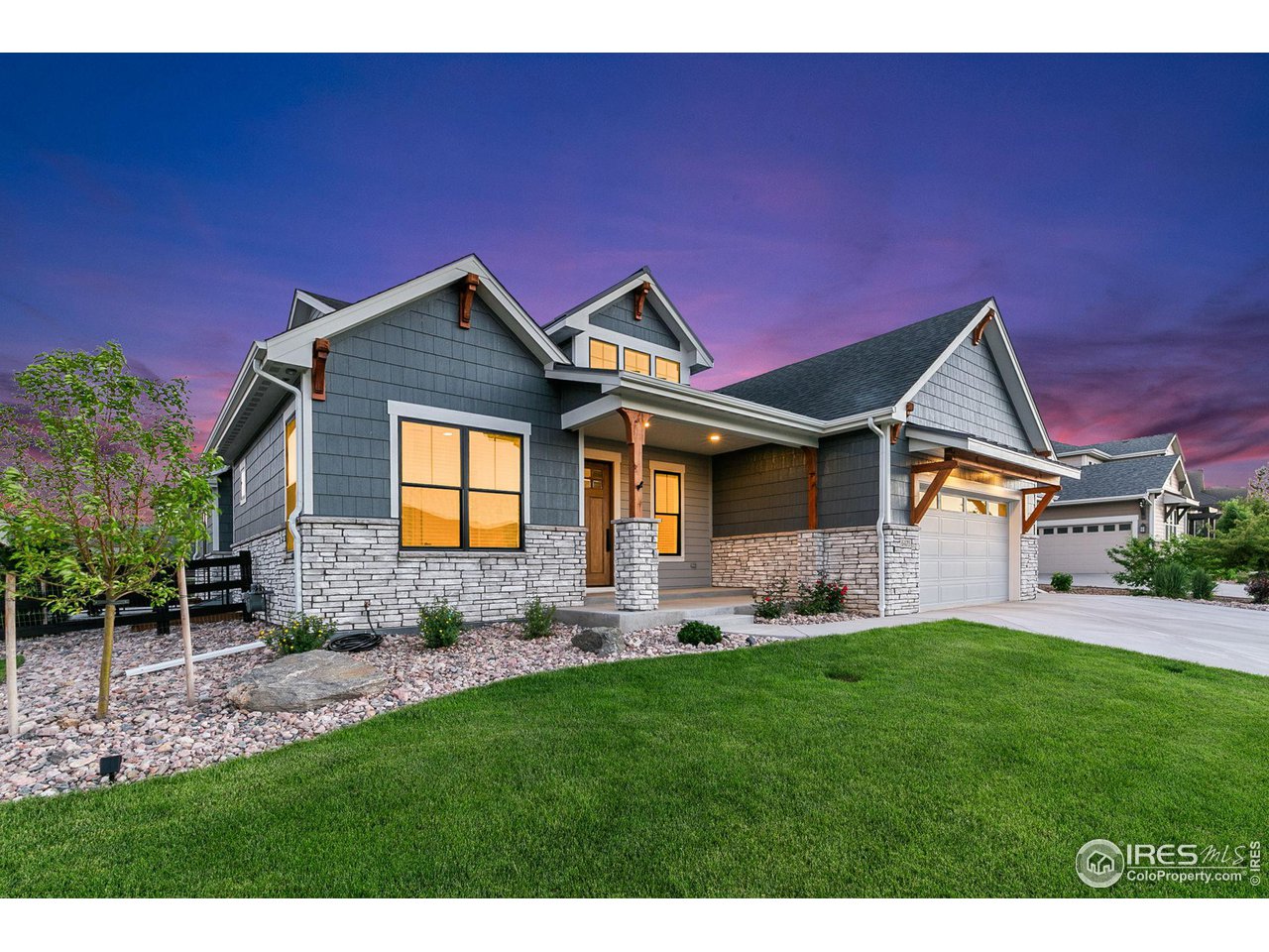 6475 Sanctuary Drive Windsor, CO 80550 - Photo 32 of 37 a front view of a house with a garden