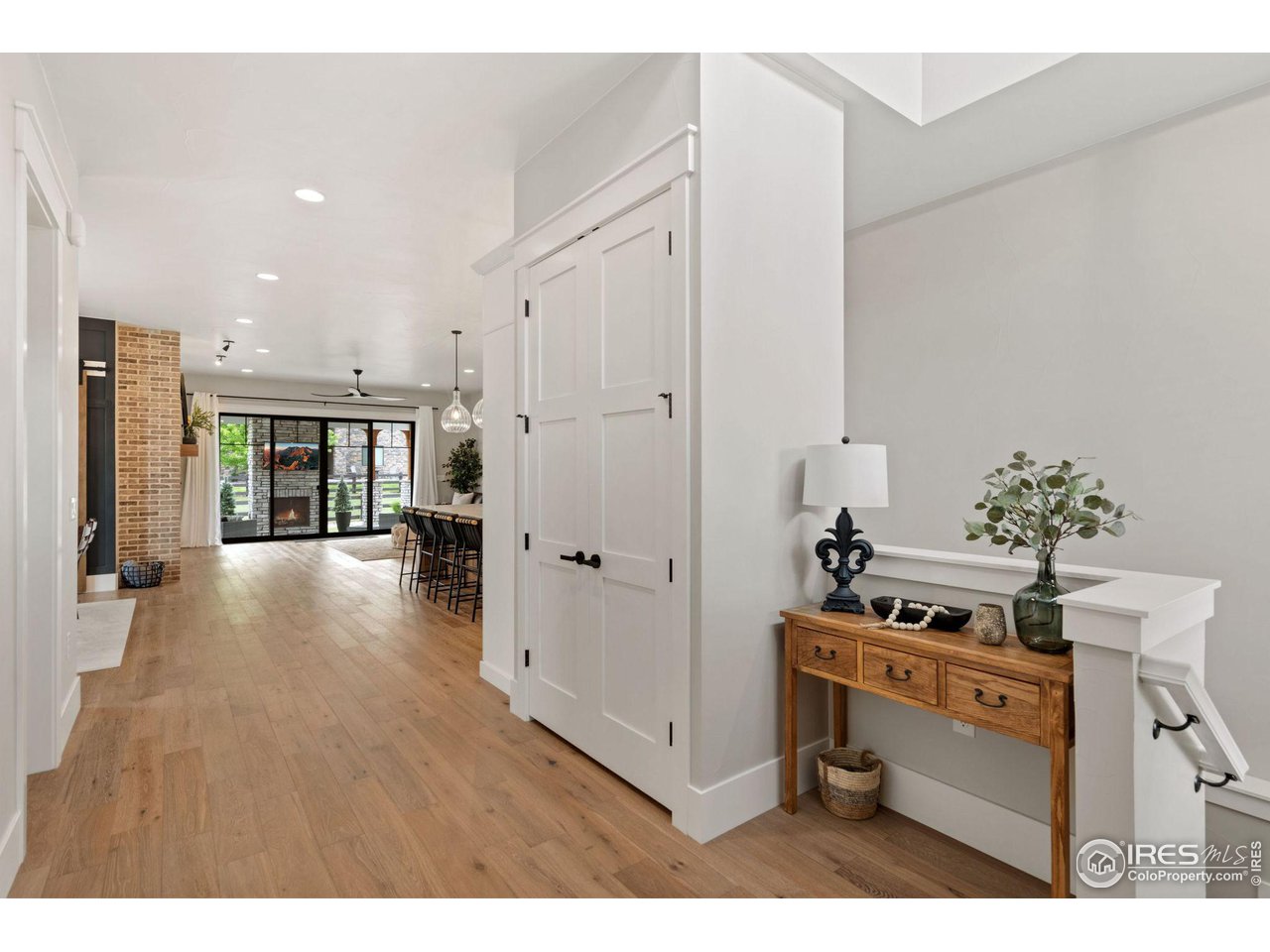 6475 Sanctuary Drive Windsor, CO 80550 - Photo 4 of 37 a hallway with a stove top oven and refrigerator