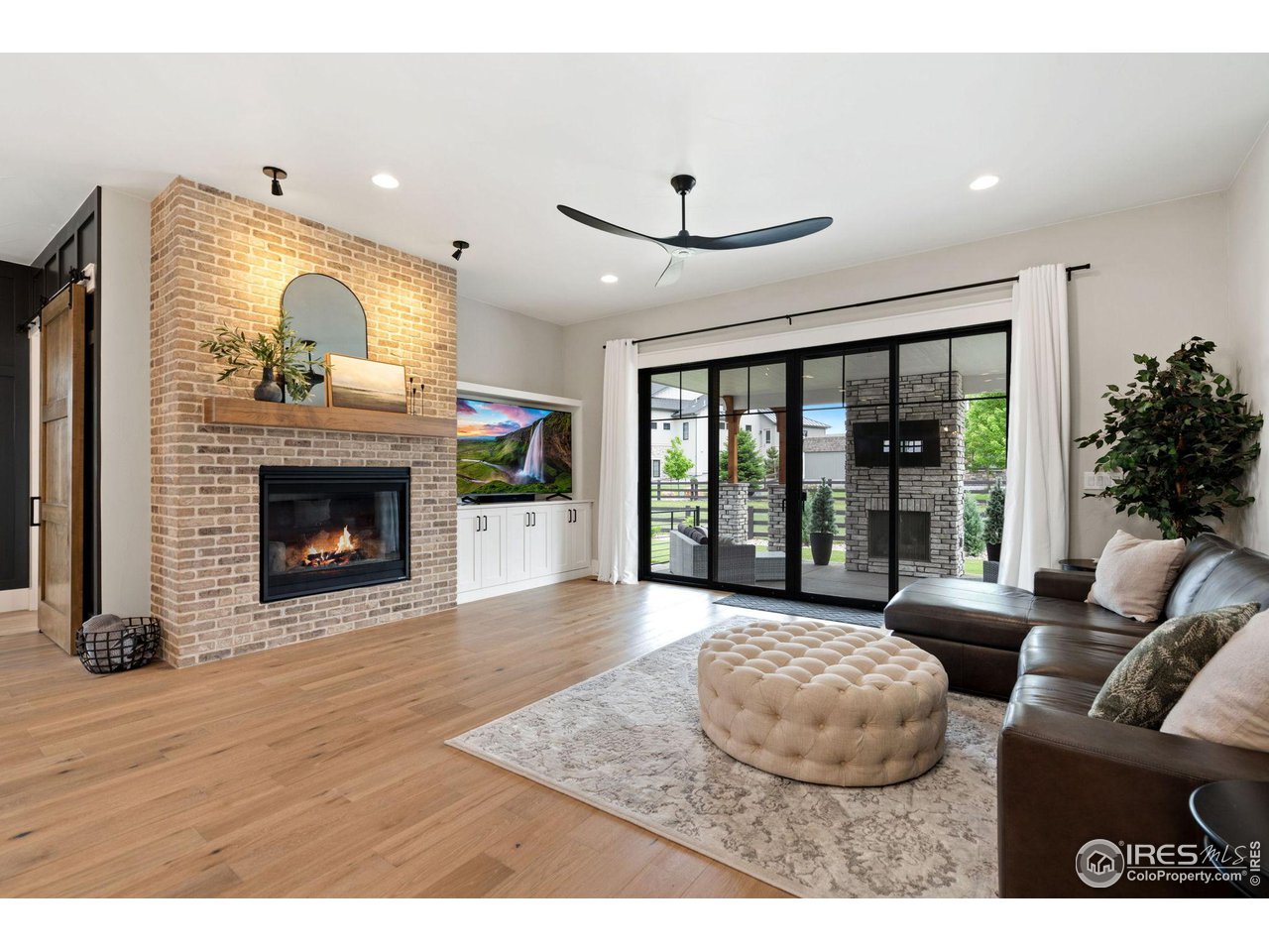 6475 Sanctuary Drive Windsor, CO 80550 - Photo 5 of 37 a living room with furniture and a fireplace