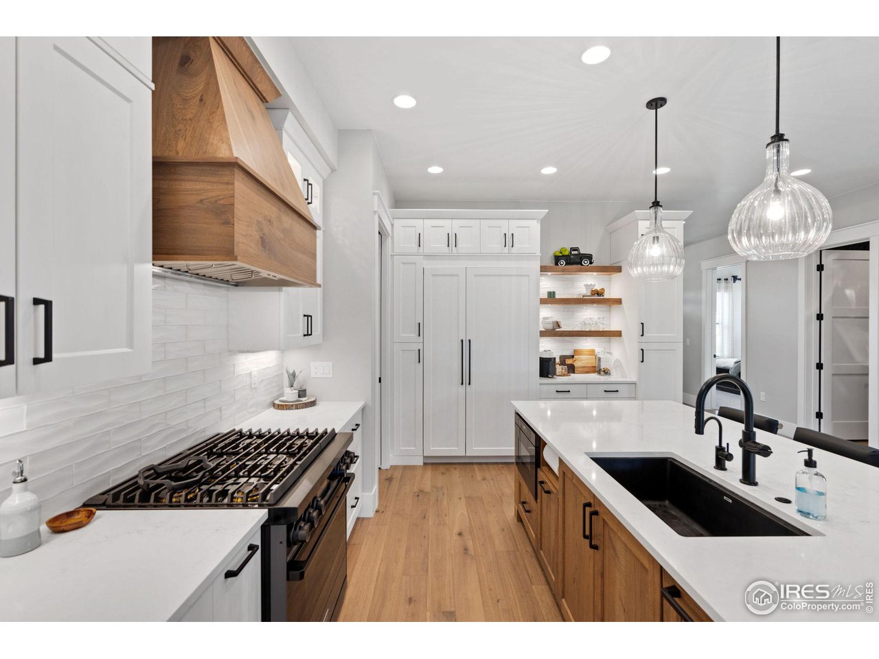 6475 Sanctuary Drive Windsor, CO 80550 - Photo 9 of 37 a kitchen that has a sink a stove and a refrigerator