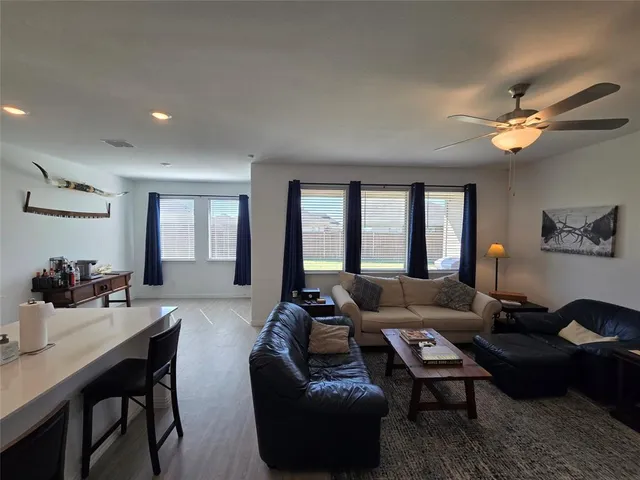a living room with furniture a chandelier and a window