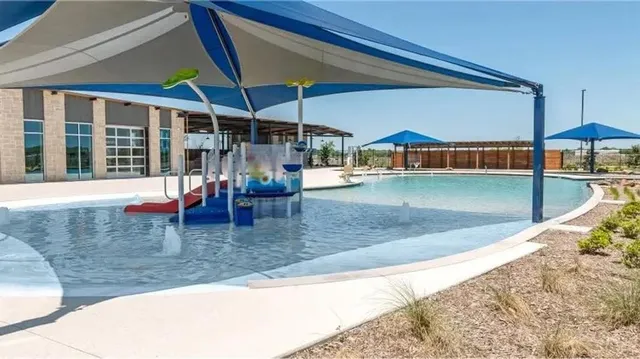 swimming pool view with a seating space