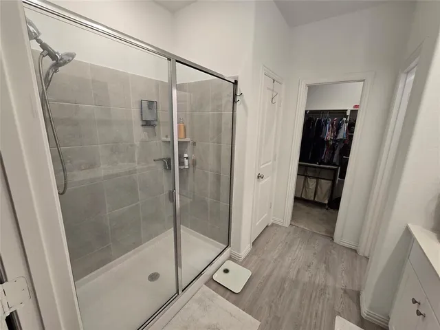 a bathroom with a shower and a glass door