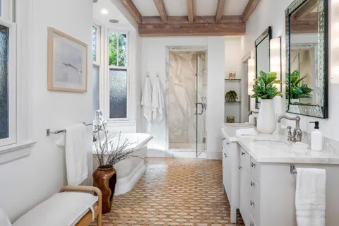 a bedroom with two beds and a window