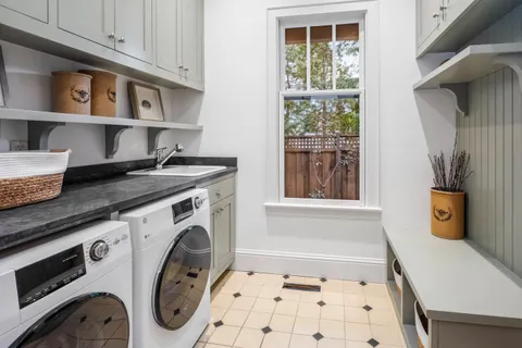 a large bed sitting in a bedroom next to a lamp and window