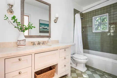 a kitchen with stainless steel appliances granite countertop a stove a sink a microwave a dining table and chairs with wooden floor