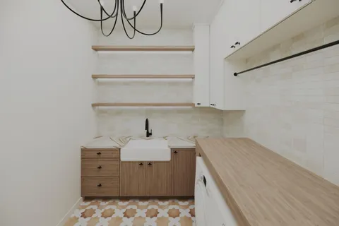 a kitchen with a sink a stove and cabinets