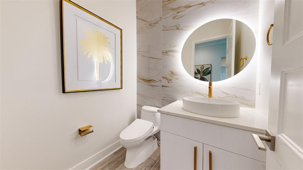 772 Gran Kaymen Way Apollo Beach, FL 33572 - Photo 14 of 43 a bathroom with a toilet sink and mirror