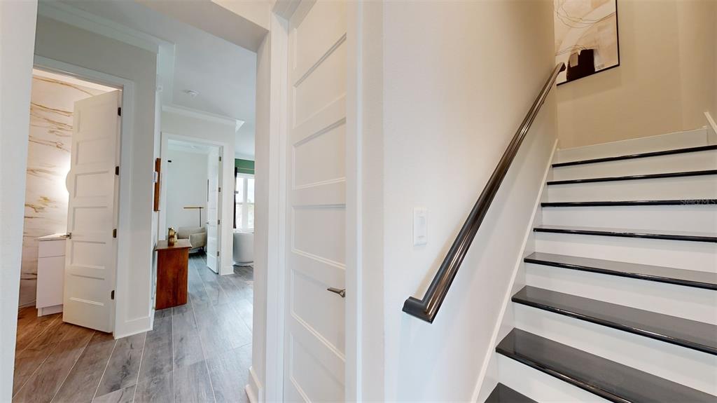 772 Gran Kaymen Way Apollo Beach, FL 33572 - Photo 16 of 43 a view of a hallway with wooden floor and entryway