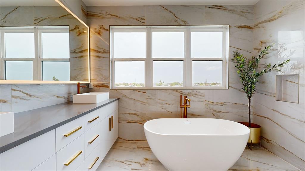 772 Gran Kaymen Way Apollo Beach, FL 33572 - Photo 25 of 43 a white bath tub sitting next to a window