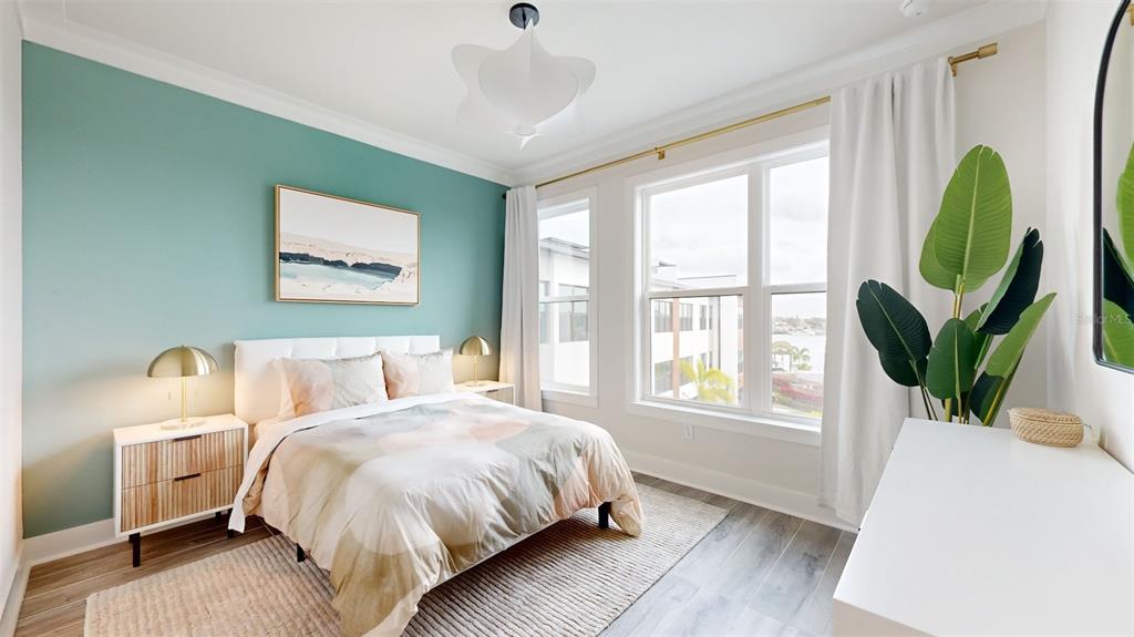 772 Gran Kaymen Way Apollo Beach, FL 33572 - Photo 28 of 43 a bed sitting in a spacious bedroom next to a window