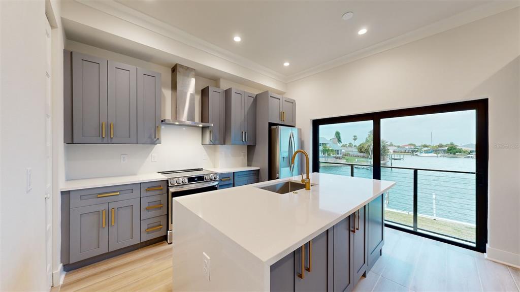 772 Gran Kaymen Way Apollo Beach, FL 33572 - Photo 5 of 43 a kitchen with a stove a sink a refrigerator and window