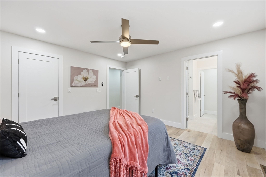 46 Horseshoe Circle Ware, MA 01082 - Photo 18 of 36 a bedroom with a bed and a chandelier