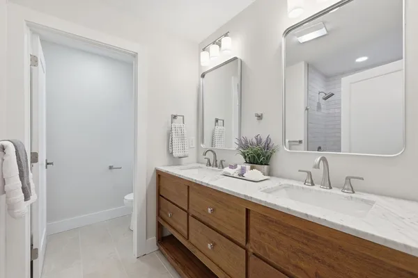 a bathroom with a double vanity sink and a mirror