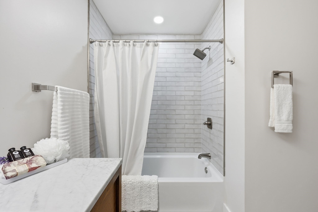 46 Horseshoe Circle Ware, MA 01082 - Photo 25 of 36 a bathroom with a tub shower and sink