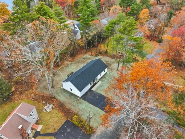 an aerial view of a house with yard