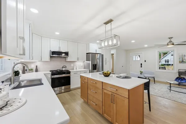 a open kitchen with stainless steel appliances granite countertop a sink stove and refrigerator