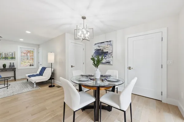 a view of a dining room with furniture wooden floor and a chandelier