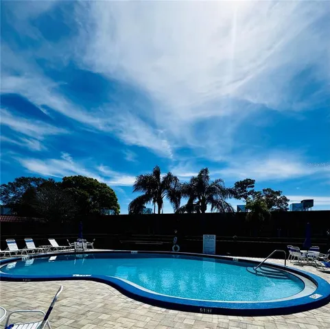a view of a swimming pool with an outdoor seating
