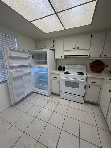 a kitchen with cabinets and appliances