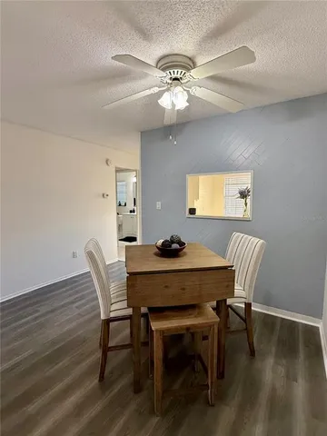 a view of a dining room with furniture wooden floor and chandelier