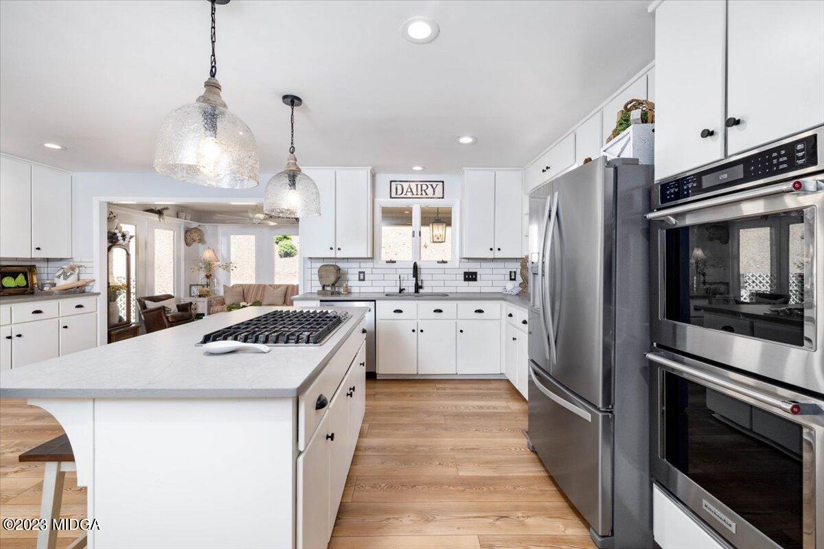 724 Forest Hill Road Macon, GA 31210 - Photo 12 of 46 a kitchen with stainless steel appliances a stove a sink and a refrigerator