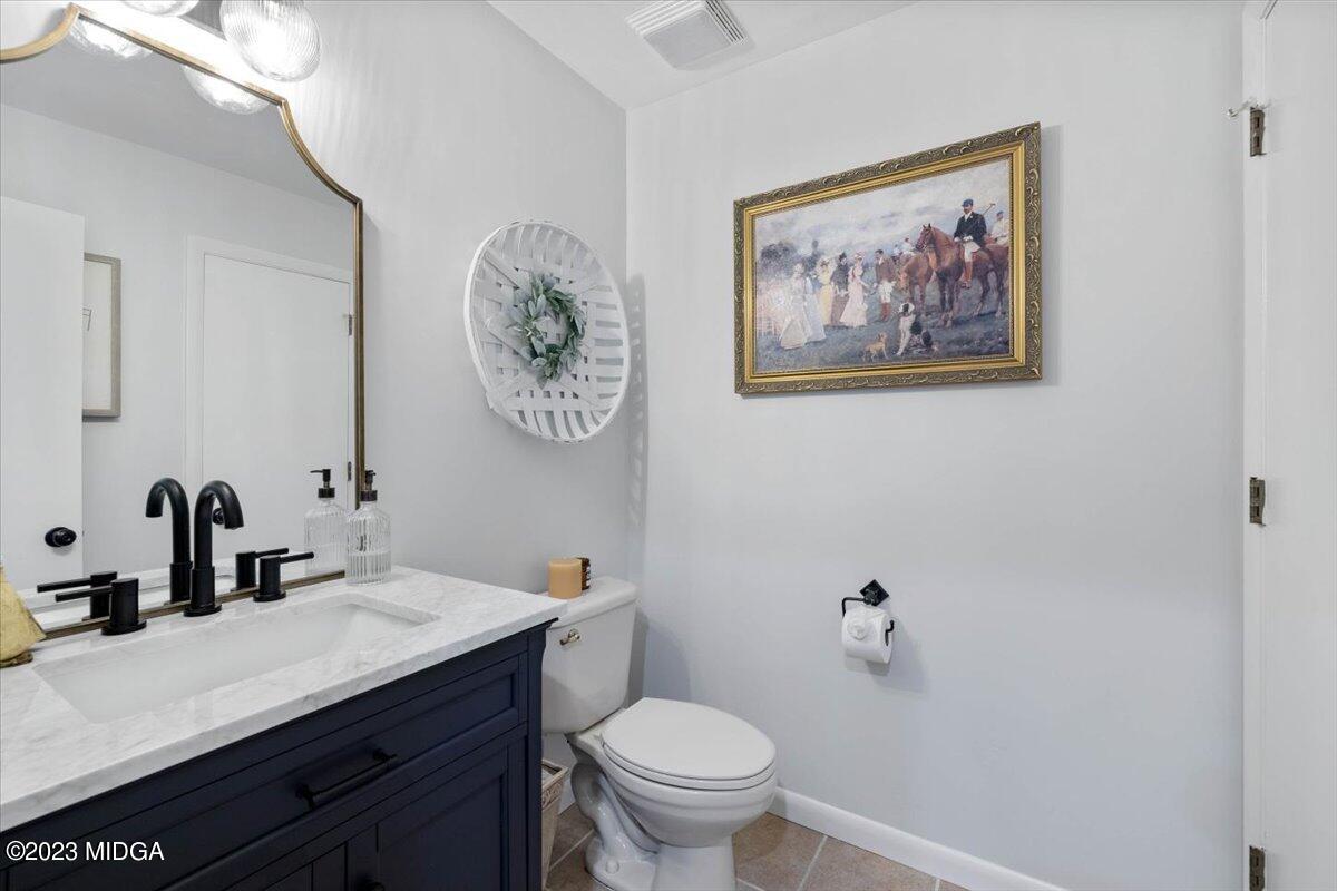 724 Forest Hill Road Macon, GA 31210 - Photo 21 of 46 a bathroom with a toilet a sink and a mirror