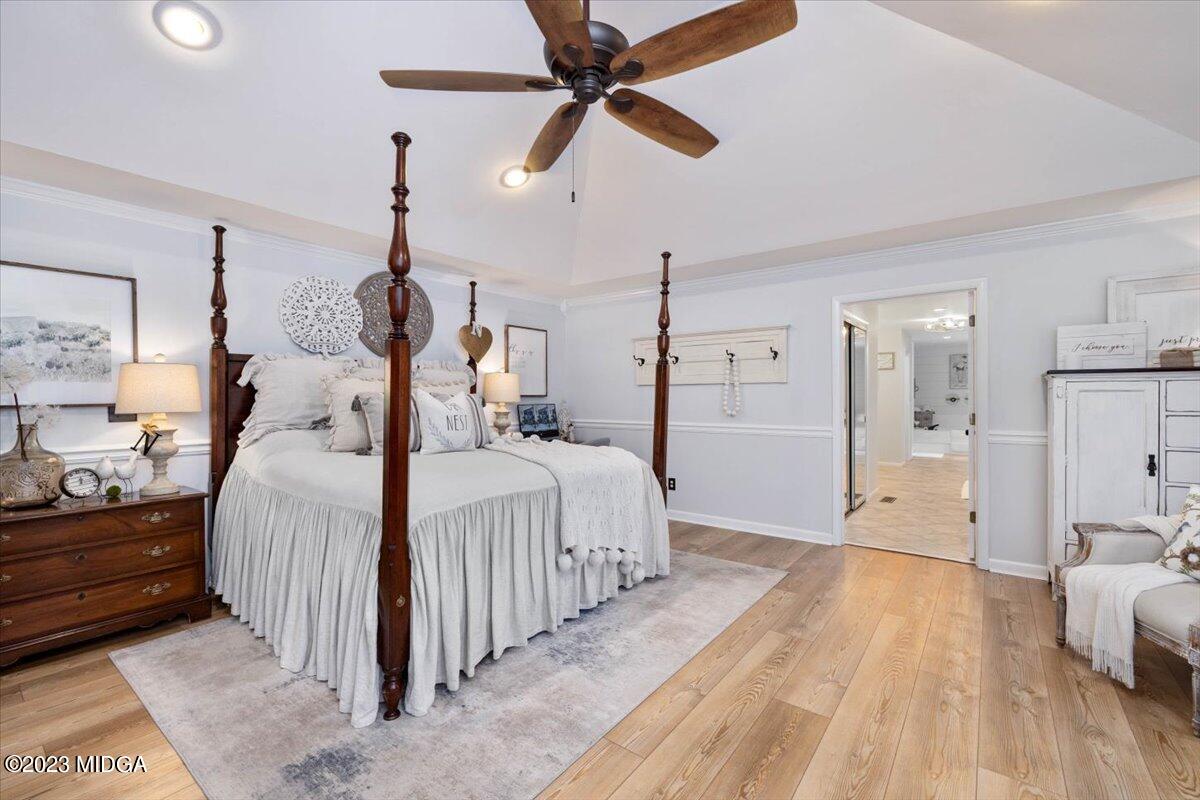 724 Forest Hill Road Macon, GA 31210 - Photo 26 of 46 a spacious bedroom with a bed and a chandelier