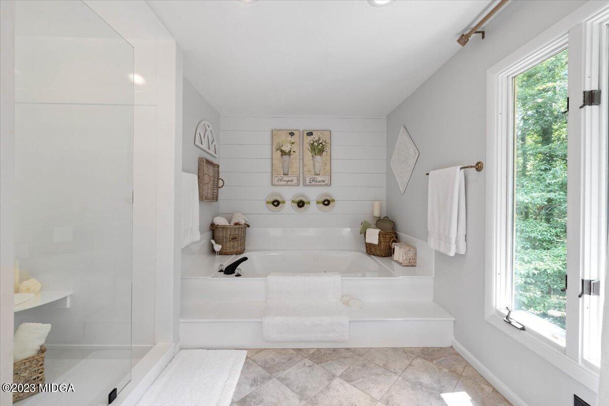 724 Forest Hill Road Macon, GA 31210 - Photo 30 of 46 a bathroom with a tub shower and window