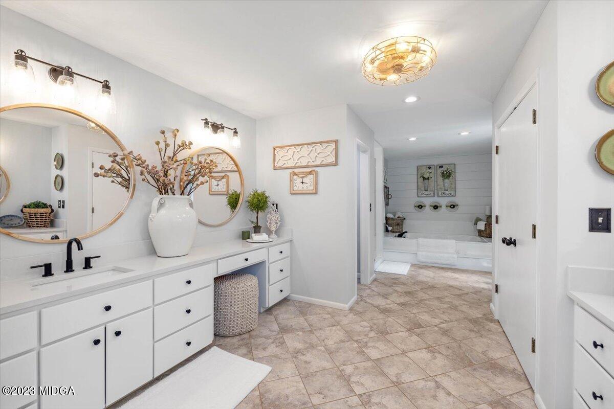 724 Forest Hill Road Macon, GA 31210 - Photo 31 of 46 a bathroom with a double vanity sink mirror and shower