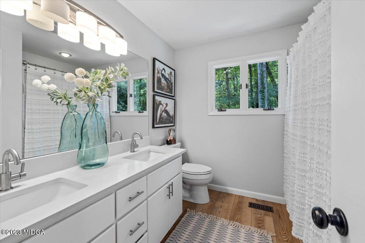 724 Forest Hill Road Macon, GA 31210 - Photo 34 of 46 a bathroom with a toilet sink and mirror