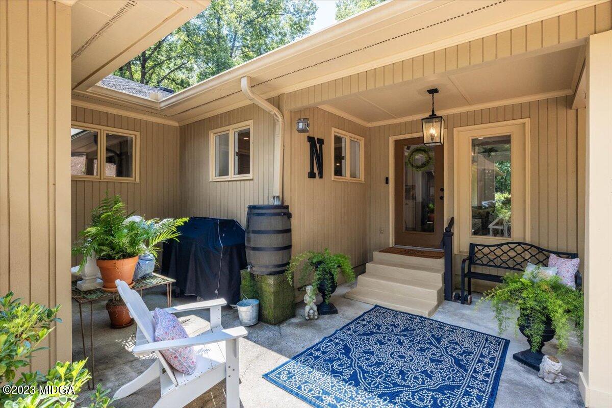 724 Forest Hill Road Macon, GA 31210 - Photo 40 of 46 a view of a patio with table and chairs potted plants