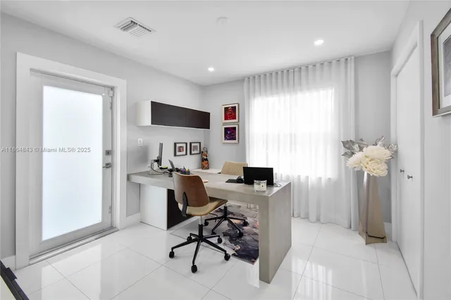 a work room with furniture and a floor to ceiling window