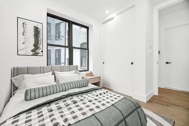 a bedroom with a large bed and a window