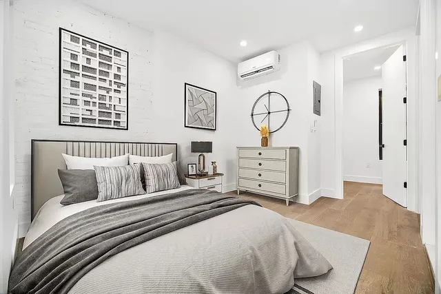 a bedroom with bed and a chandelier