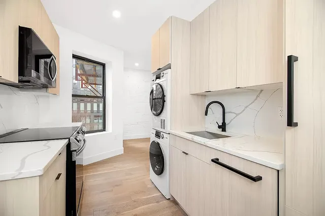 a kitchen with stainless steel appliances granite countertop a sink and a microwave