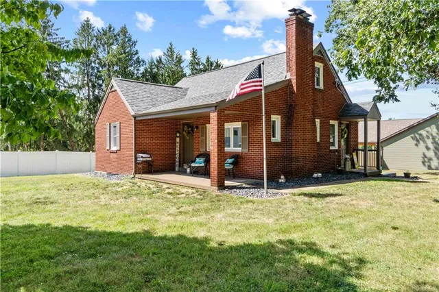 a house that has a tree in front of it