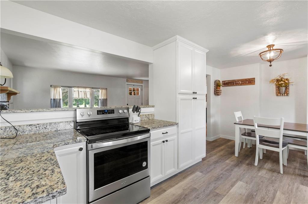 12680 Veronica Lane Irwin, PA 15642 - Photo 12 of 29 a kitchen with a stove and white cabinets