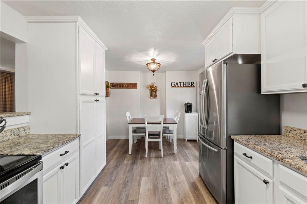 12680 Veronica Lane Irwin, PA 15642 - Photo 13 of 29 a kitchen with granite countertop white cabinets and stainless steel appliances
