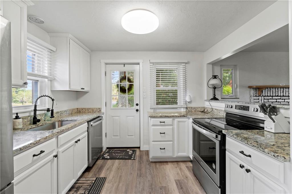 12680 Veronica Lane Irwin, PA 15642 - Photo 14 of 29 a kitchen with granite countertop a sink stove and cabinets