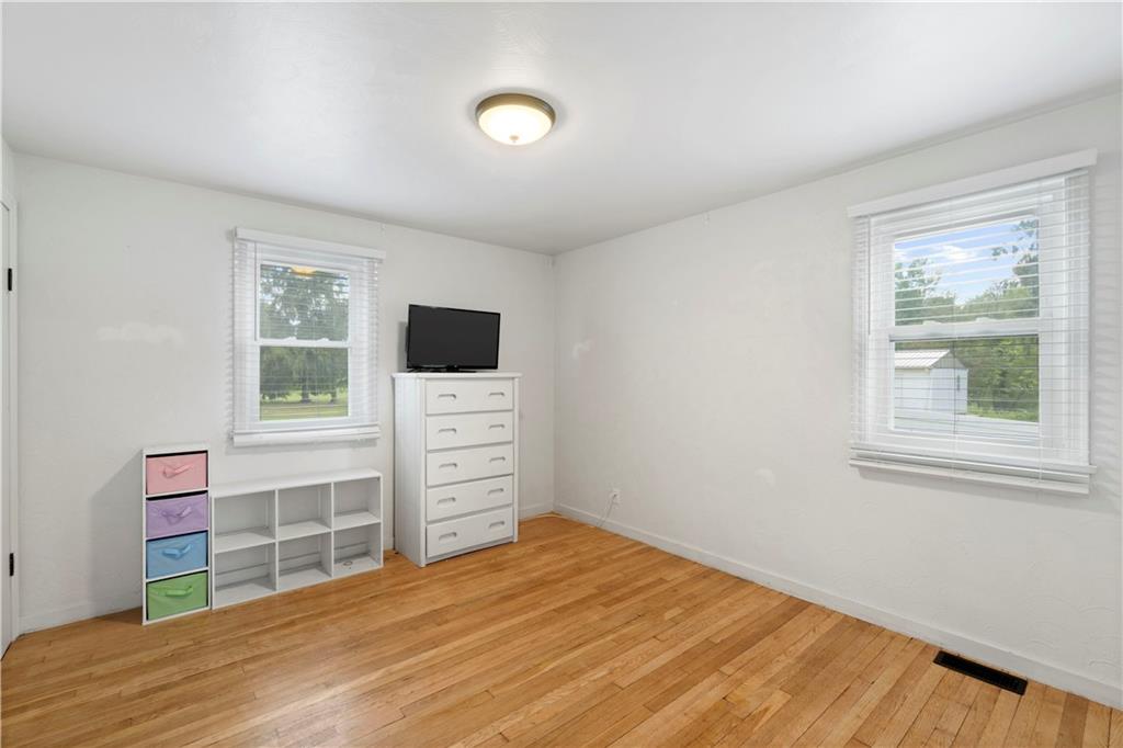 12680 Veronica Lane Irwin, PA 15642 - Photo 17 of 29 a room with furniture a flat screen tv and wooden floor