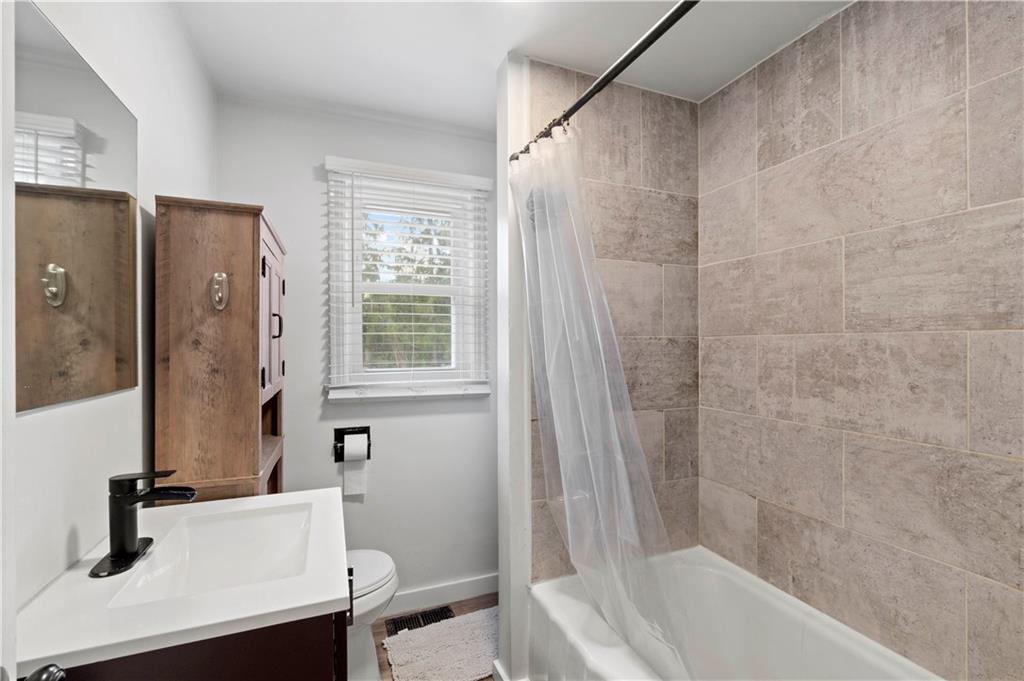 12680 Veronica Lane Irwin, PA 15642 - Photo 20 of 29 a bathroom with a sink a mirror a bathtub and shower