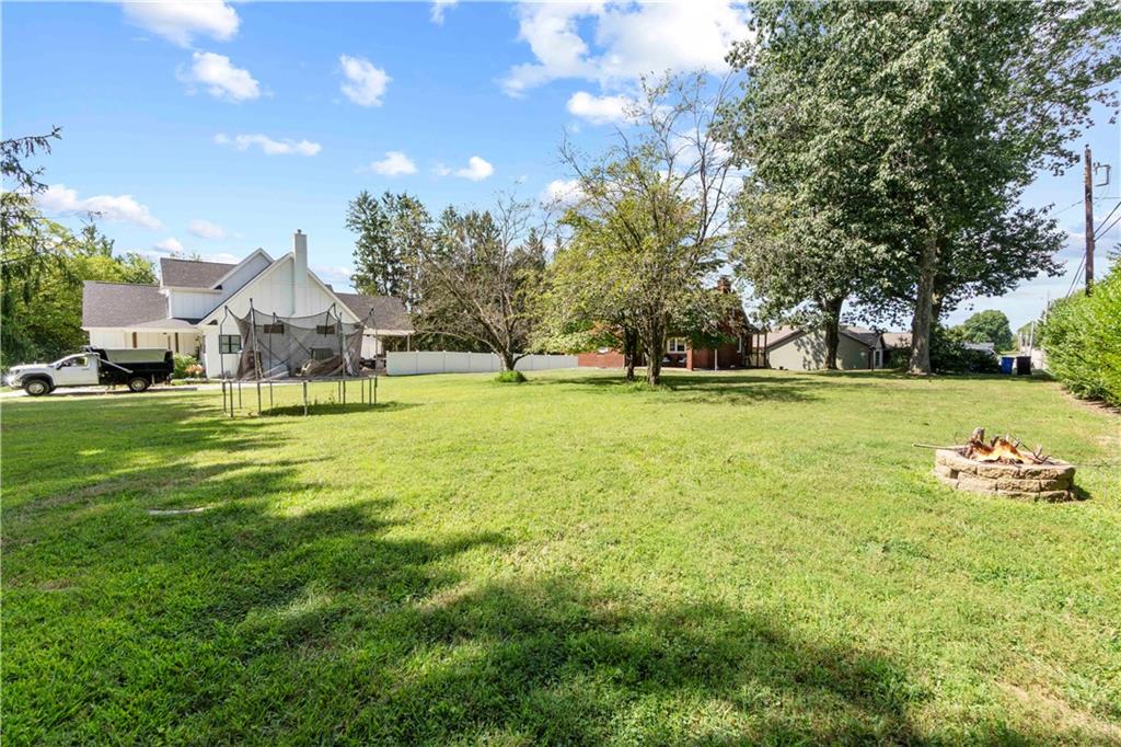 12680 Veronica Lane Irwin, PA 15642 - Photo 6 of 29 a swimming pool is sitting in the grass with large trees