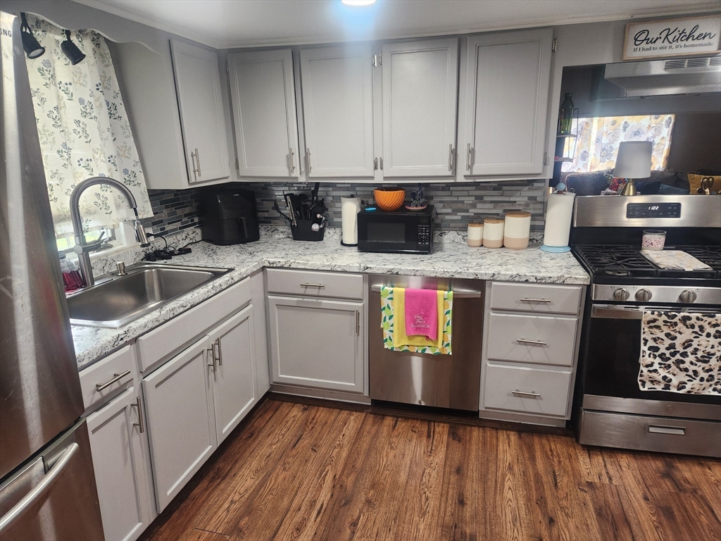53 Temple Street Spencer, MA 01562 - Photo 11 of 20 a kitchen with granite countertop white cabinets and white appliances