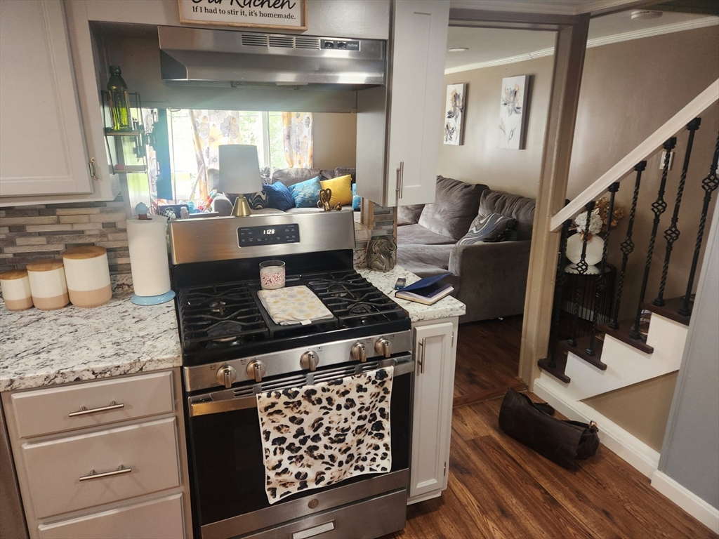 53 Temple Street Spencer, MA 01562 - Photo 19 of 20 a kitchen with stainless steel appliances granite countertop a stove a sink and a refrigerator