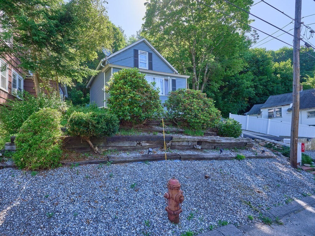 53 Temple Street Spencer, MA 01562 - Photo 2 of 20 a front view of a house with a yard