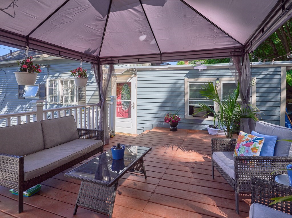 53 Temple Street Spencer, MA 01562 - Photo 4 of 20 a view of a patio with couches and a table and chairs under an umbrella