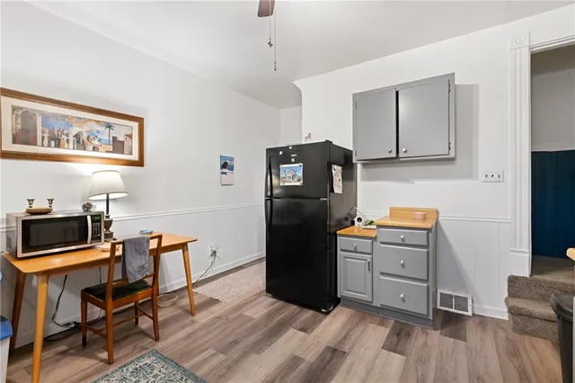 a view of a workspace with furniture and a rug