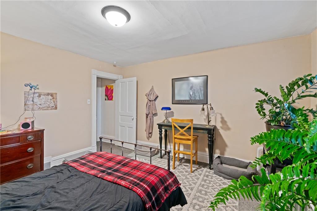 1630 Poplar Avenue Braddock, PA 15104 - Photo 15 of 25 a bedroom that has a bed and a chair in it