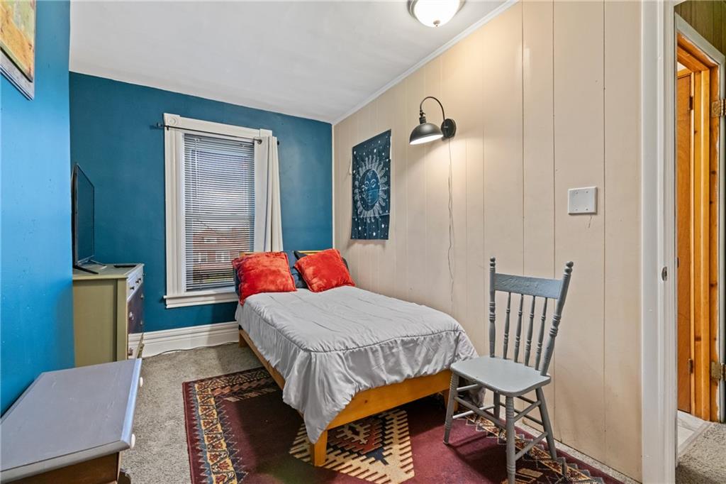 1630 Poplar Avenue Braddock, PA 15104 - Photo 16 of 25 a bedroom with a bed and wooden floor